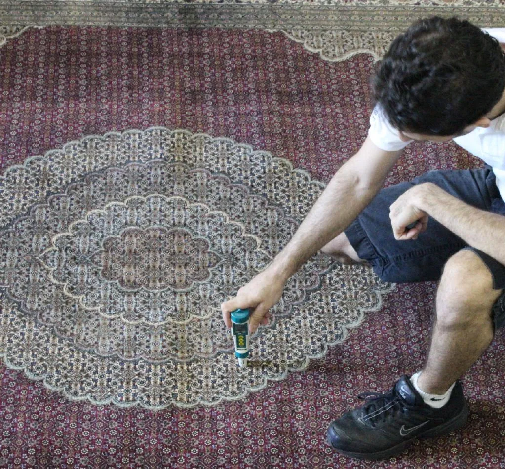 Close-up of a pH meter reading a rug's fibers before any water is used